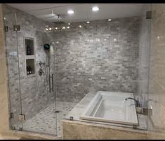 a bathroom with a walk in shower next to a bath tub