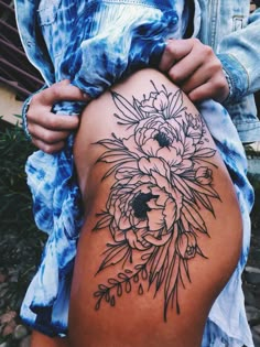 a woman's thigh with flowers on it