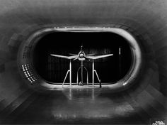 an airplane that is sitting in the middle of a tunnel with bars on each side