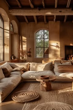 a living room filled with lots of furniture next to a fire place in a building