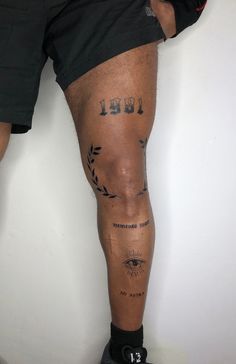 a man with tattoos on his legs and leg