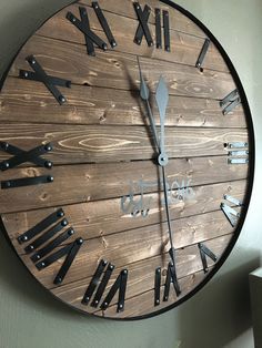 a wooden clock with roman numerals on it