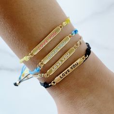 Choose who you love while you use this trendiest colorful bracelet to express it. An everyday use bracelet in cotton cord and a gold-plated plaque to tell "I Love You".Express your feeling in enchanting words on shining gold.Product specs: Adjustable cotton cord Gold-plated 18k over brass Enamel words Trendy Gold Friendship Bracelets For Everyday, Trendy Personalized Gold Friendship Bracelets, Casual Gold Bracelet With Adjustable Cord, Inspirational Gold Friendship Bracelets, Gold Friendship Bracelet For Best Friend, Personalized Gold Casual Friendship Bracelets, Inspirational Gold Friendship Bracelets Gift, Inspirational Adjustable Gold Friendship Bracelets, Gold Bracelet With Sliding Knot For Best Friend