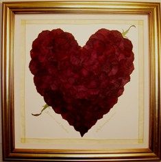 a heart made out of flowers in a gold frame