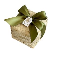 a close up of a basket with a green bow on it and a tag in the middle