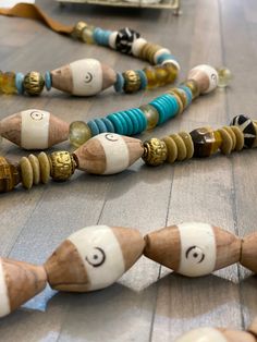 "Hand carved bone and wood beads from Africa The look lovely on my leather strap necklaces or any large bead necklace or bracelet Choose from 2 or 5 beads Size is approximately 34mm (1.3\") long x 20mm (.80\") wide 3mm hole Inscribed with semicircle or circle pattern-each one varies Beautifully made! No two are identical-each one may vary due to the handmade nature of these beads" Artisan Oval Wooden Beads, Brown Wooden Necklace With Large Beads, Adjustable Multi-strand Wooden Bead Jewelry, Traditional Brown Large Beads, Black Multi-strand Wooden Beads Jewelry, Large Bead Necklace, Carved Bone, Bone Beads, Circle Pattern