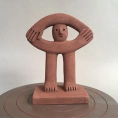 a clay sculpture sitting on top of a table