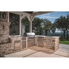 an outdoor kitchen with grill and sink