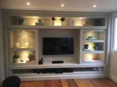 a flat screen tv sitting on top of a white entertainment center