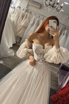 a woman is taking a selfie in her wedding dress while looking into the mirror