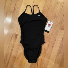 Nike Hydrastrong Solid Black One Piece Swim Suit. New With Tags And Hygiene Liner Still Intact. Size 28. Still Have Box. Nike Swim, Black One Piece, One Piece Swim, Black Swimsuit, Swim Suit, Black Nikes, Solid Black, Womens Swim, Nike Women