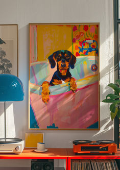 a dog is hanging on the wall next to a table with records and a lamp