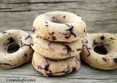 a pile of chocolate chip cookies sitting on top of a wooden table next to each other