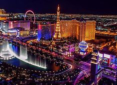 the las vegas strip is lit up at night with colorful lights and fountains in the water