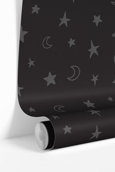 a black and white wallpaper with stars, moon and crescents on the side