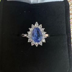 Tanzanite And Cz Ring Size 7 I Believe Great Condition Luxury Tanzanite Pear-shaped Jewelry, Luxury Pear-shaped Tanzanite Jewelry, Elegant Cubic Zirconia Gemstones With Vvs Clarity, Elegant Lab-created Sapphire Diamond Ring, Elegant Cubic Zirconia Gemstones For Promise Ring, Elegant Diamond Gemstones With Halo Setting, Formal Tanzanite Jewelry With Diamond Accents, Exquisite Tanzanite Jewelry With Prong Setting, Elegant Cubic Zirconia Gemstone Ring