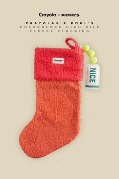 an orange christmas stocking with a tag on it