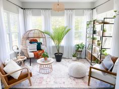 a living room filled with furniture and plants