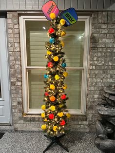 a decorated christmas tree in front of a window