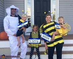 three adults and two children dressed up in bee costumes on the front steps of a house