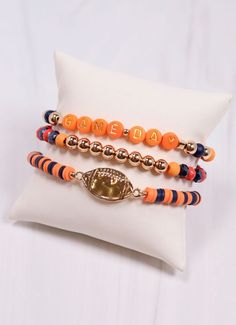 This bracelet set has three separate pieces that can be worn all together or individually. They feature two tone beading, stacked discs, a shiny metal football charm and "Game Day" accent beads as well. Stretches to fit most wrists. Fall Bracelets, Team Bracelets, Football Bracelet, The Friendship, Colorful Bracelets, Team Colors, Bracelet Set, Friendship Bracelets, Game Day