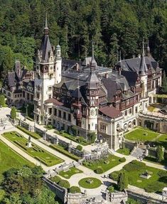 an aerial view of a large mansion in the woods