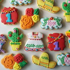 decorated cookies are arranged on a white surface