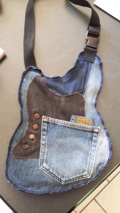 a purse made out of old jeans with a guitar design on the front and back