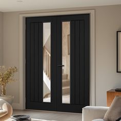 a living room filled with furniture and a black door