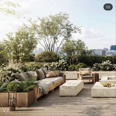 an outdoor living area with couches, tables and potted plants