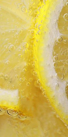 the lemon is sliced in half with water droplets on it