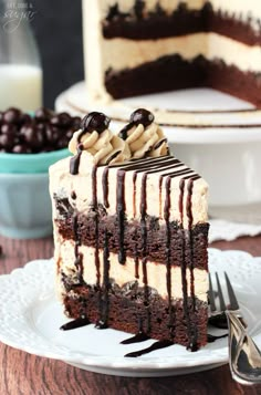 a slice of cake on a plate with chocolate and peanut butter drizzles