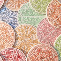 many colorful paper plates with designs on them