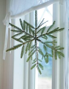 a pine cone hanging from the side of a window