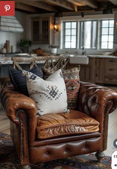 a brown leather chair sitting on top of a wooden floor