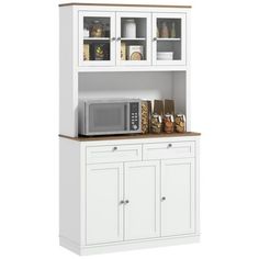 a white kitchen hutch filled with lots of cupboards and food on top of it