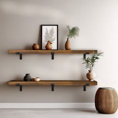 two wooden shelves with vases and plants on them against a white wall in an empty room