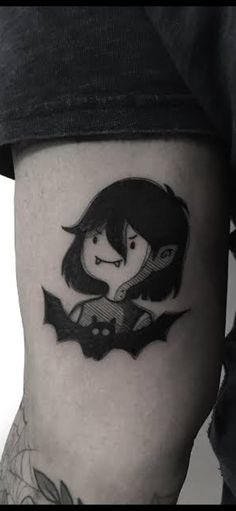 a woman with a bat tattoo on her leg