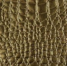 the texture of an alligator skin pattern in gold color, closeup photo stock photography