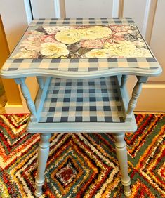 a blue table with flowers painted on it