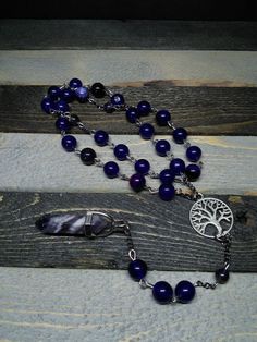 This is a beautiful re-imagined rosary based on the classic Catholic rosary.  The  beads are amethyst.  There are three decades of nine beads each.  The center is a tree of life, and I have capped it off with a amethyst pendent which can double as a spirit guide pendulum.  With this rosary I'm including a simple chant which has resonated with me, but feel free to use your own!   Pagan/witch prayer chant: Knot one, the work's begun. Knot two, my aim is true. Knot three, it will be. Knot four, pow Spiritual Gemstone Beads Rosary, Spiritual Rosary With 8mm Beads, Spiritual Beaded Rosary For Jewelry Making, Spiritual Rosary With 8mm Beads For Healing, Bohemian Rosary With 108 Beads For Healing, Bohemian Rosary Bracelet With 8mm Beads For Meditation, Adjustable Spiritual Rosary For Healing, Spiritual Rosary With Natural Stones As Gift, Handmade Spiritual Healing Rosary