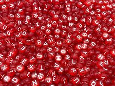 red beads with white letters and numbers on them