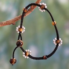 Macrame Anklet Crafted by Hand with Tiger's Eye and Silver - Blossoming Quartet | NOVICA Cheap Macrame Bracelet Jewelry, Cheap Adjustable Macrame Bracelets, Macrame Jewelry Bracelets, East Bracelets To Make, Simple Bead Macrame Bracelet, Macrame Bracelet Patterns Novica, Macrame Anklet, Black Anklet, Ankle Bracelets Boho