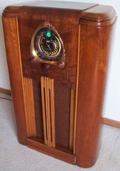 an old fashioned wooden radio sitting on the floor