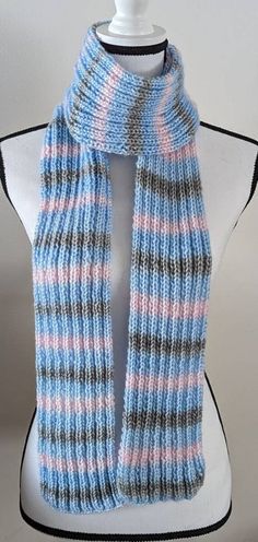 "New Handmade Knit Scarf in Ice Yarns Picasso in Powder Blue, Grey, and Light Pink - 5\" x 70\" This beautiful scarf is made of soft, warm, and slightly shiny Ice Yarns Picasso yarn - an acrylic and polyester blend yarn - in self-striping shades of Powder Blue, Grey, and Light Pink. Machine wash cold and lay flat to dry. The pattern on this scarf is a 2x2 ribbing. This classic pattern gives the scarf a tailored look while remaining side-by-side stretchy. Yarn Content: 44% Acrylic, 56% Polyester Pink Machine, Beautiful Scarf, Handmade Knit, Classic Pattern, 72 Hours, Handmade Knitting, Side By Side, Powder Blue, Knit Scarf