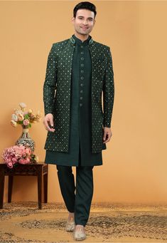 Art Silk Sherwani in Dark Green This Readymade attire is Enhanced with Buttons, Resham and Stone Work. Crafted in Chinese Collar Neck and Full Sleeve Available with an Art Silk Pant in Dark Green and an Art Silk Long Jacket in Dark Green Do note: Bottom Style and Footwear shown in the image is for presentation purposes only. Half to one inch may vary in measurement. (Slight variation in actual color vs. image is possible) Bottle Green Sherwani For Men, Green Indo Western Outfits Men, Bottle Green Kurta For Men, Green Indo Western Outfits, Western Outfits For Men, Indian Wedding Clothes For Men, Indo Western Sherwani, Sherwani Groom, Sherwani For Men