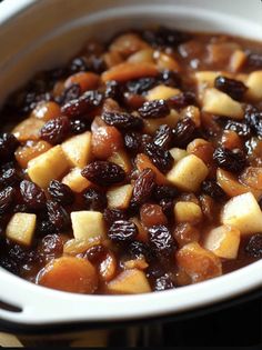 a white bowl filled with apples and raisins