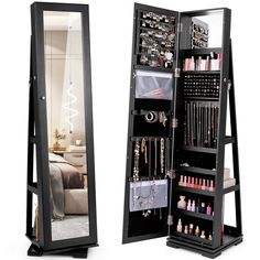 an open black jewelry cabinet next to a mirror