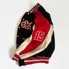 "Offered here is this beautiful 1958 Creighton Economy Braves jacket from the Polar League of Manitoba and Saskatchewan. The wool buttoned jacket is lettered with \"Braves\" across the front. The right sleeve features a \"Polar League 1958\" patch. The left sleeve features the number \"15\". The jacket is nicely accentuated with an array of creme-navy-red colors around the neck, sleeves and sleeve ends. A \"Schachter's\" manufacturer's label stitched on the inside collar. This is an amazing piec Retro Winter Varsity Jacket With Letter Print, Retro Letter Print Varsity Jacket For Winter, Retro Winter Varsity Jacket, Retro Wool Varsity Jacket For Streetwear, Vintage Varsity Jacket With Button Closure For Winter, Vintage Winter Varsity Jacket With Button Closure, Vintage Black Varsity Jacket For Winter, Vintage Black Outerwear With Letter Print, Retro Wool Varsity Jacket For Fall