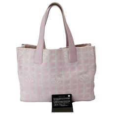 Item Details: Designer: CHANEL?ÿ Model:?ÿTravel Line Retail:?ÿN/A Style: Tote Bag Material: Nylon and Leather Color: Light Pink Date: France Measurements: W 14" x H 10" D 6" Accessories:?ÿity Card. Condition Detail: Very Good - The Item is gently used and may have minor corner rubbing, light leather tanning, some inside stain marks, and slight signs of use on hardware. See the listing description for details. Outside: Signs of use. Inside: Dirt marks, signs of use. Nylon: Dirt marks, signs of use. Leather: Scratches, wrinkles, signs of use. Corners: Dirt marks, signs of use. Hardware: Scratches, signs of use. Strap: Light scratches, wrinkles,?ÿsigns of use. Smell: No Smell. Please check the details and pictures before purchasing.Please do not hesitate to ask questions regarding our product Chanel Tote Bag, Chanel Tote, Pink Chanel, Chanel Model, Chanel Accessories, New Line, Chanel Bags, Shoulder Tote Bag, Nylon Bag